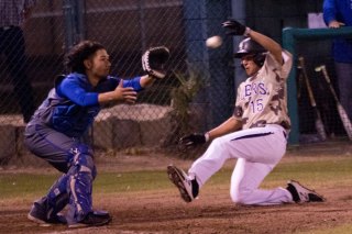 A sliding Alex Sanchez scores the Tigers second run Thursday night. He also pitched a shutout against Hanford West. 